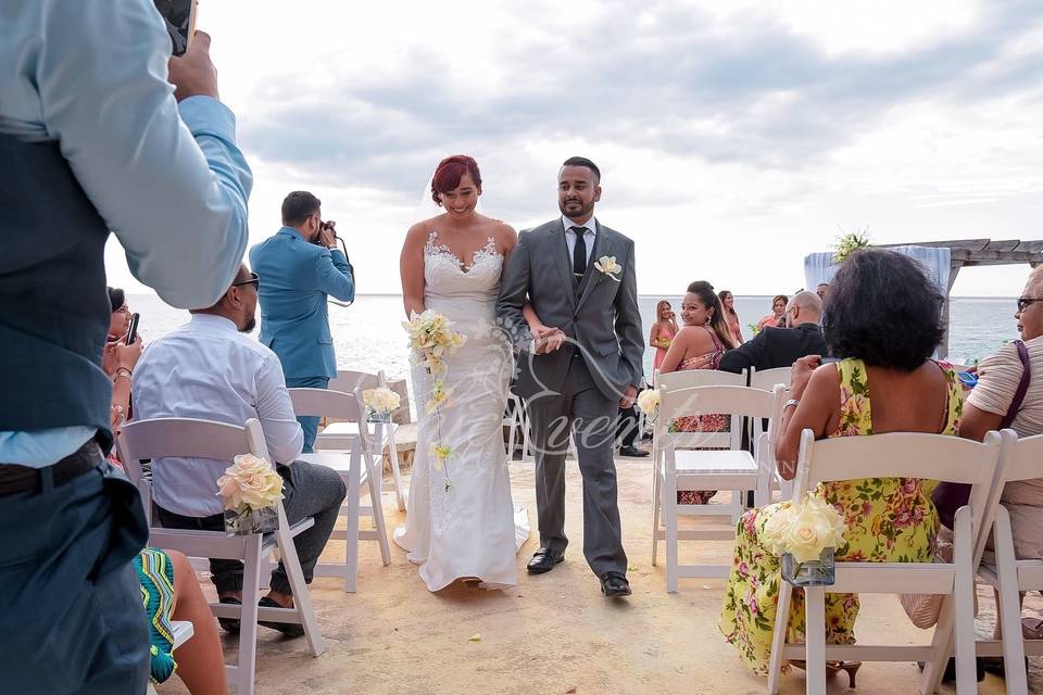 Aisle decor of white roses in square vase on white chairs