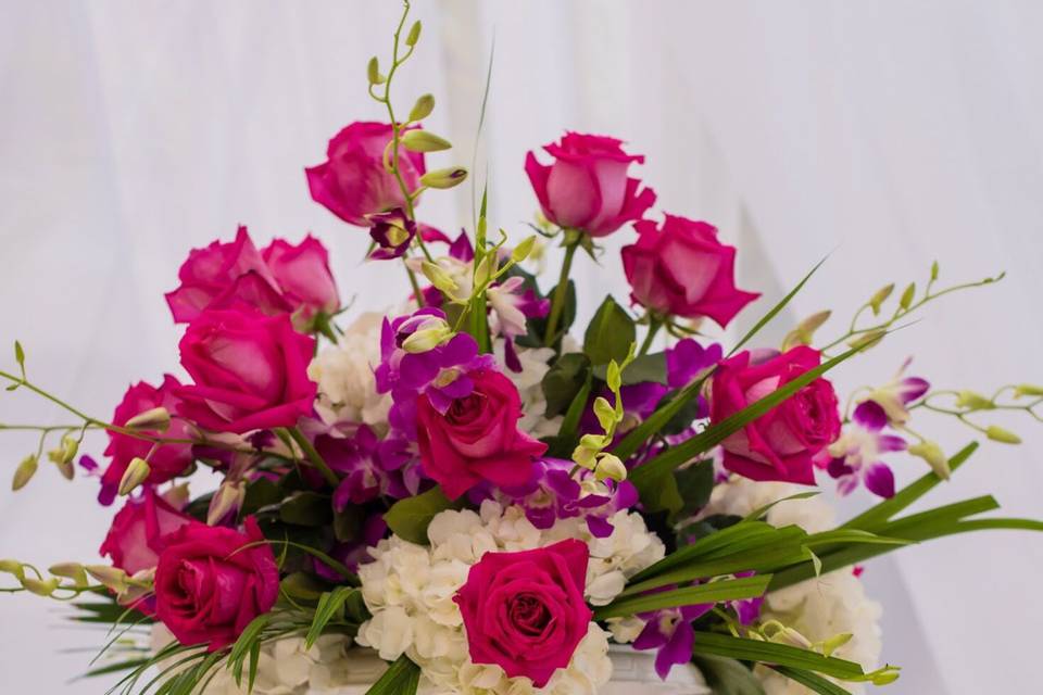 Pedestal piece for wedding ceremony - Fuschia roses, purple dendrobium orchids, white hydrangeas with greenery