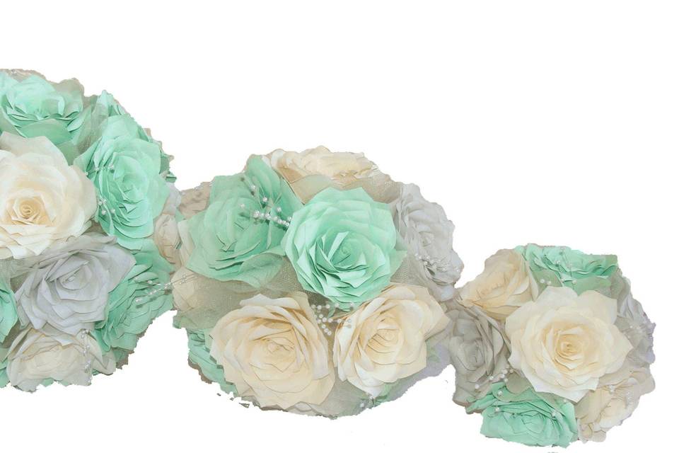 Our most popular design. These bouquets are made of mint green, silver and ivory paper coffee filter Roses. Each flower petal is hand cut, individually painted, hung to dry, assembled and shaped to create the perfect Rose. Between the flowers are delicate pearl sprays and shimmering ivory tulle. The stems are wrapped in silver satin ribbon with rows of silver rhinestone mesh ribbon around the top and bottom for extra sparkle.