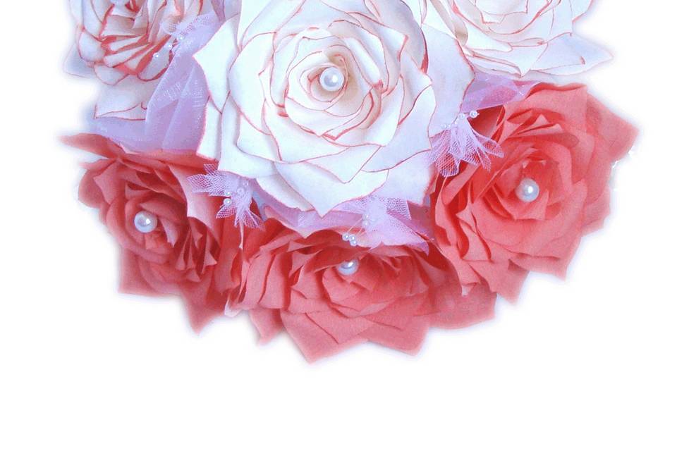 This lovely bouquet uses handmade coffee filter paper Roses and tulle and pearl sprays. Each flower petal is hand cut, individually painted coral or white with just the tips coral, hung to dry, assembled and shaped to create the perfect realistic looking Rose. Each Rose has a glass pearl in the center. There is beautiful white satin and organza wired ribbon at the base of the Roses. The handle is wrapped in white satin ribbon.
