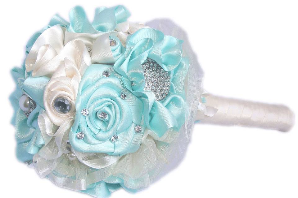 Bouquet is shown in mint green and ivory in the small size. This Bouquet is made up of over 20 satin ribbon and organza flowers each with their own brooch, rhinestones, pearls and beautiful decorative buttons. The handle is wrapped in satin ribbon and adorned with ivory bows and satin roses..