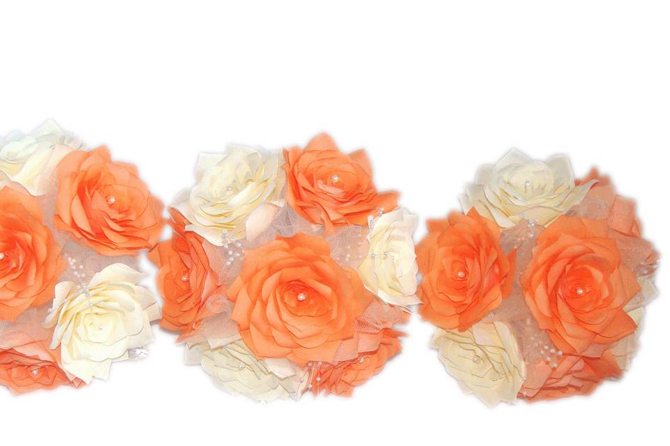 This lovely bouquet is made of orange and ivory coffee filter paper Roses. Each flower petal is hand cut, individually painted, hung to dry, assembled and shaped to create the perfect Rose. Between the flowers are delicate pearl sprays and ivory organza, The stems are wrapped ivory satin ribbon with tiny ivory bows and orange sheer ribbon.