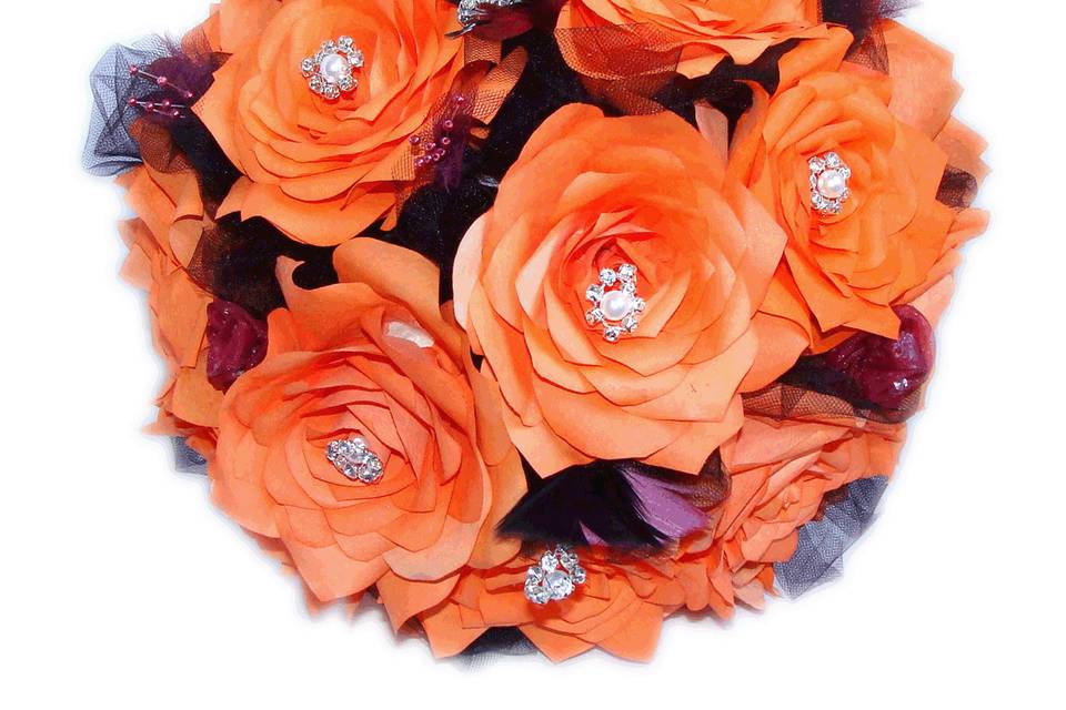 Dark orange or persimmon and plum handmade coffee filter paper roses make up this bouquet. We have added pearl and rhinestones to the center of the top Roses for added glamour. There are black and plum tulle and pearl flowers and delicate feathers between the flowers. The handles are wrapped in plum ribbon, black rhinestone ribbon and organza flowers. Each flower petal is hand cut, individually painted, hung to dry, assembled and shaped to create the perfect Rose. Please contact us for different colors or quantity discounts.