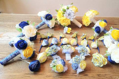 Bouquets are shown in yellow and Royal blue paper coffee filter Rose and Peonies along with paper sheet music flowers.