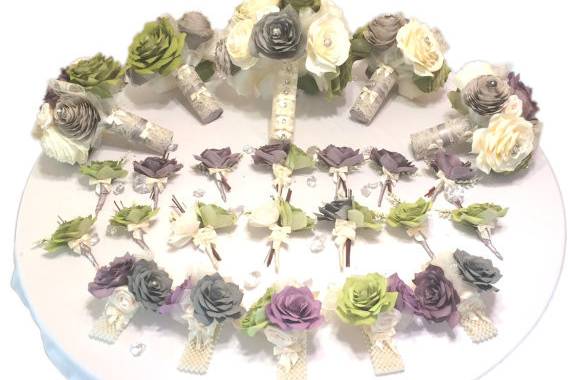 Wedding party package shown in plum, olive green and grey but can be made in colors of your choice. Flowers have a pearl and rhinestone center. There is lace, tulle and pearl sprays surrounding the flowers with satin ivory ribbon and lace around the handles.