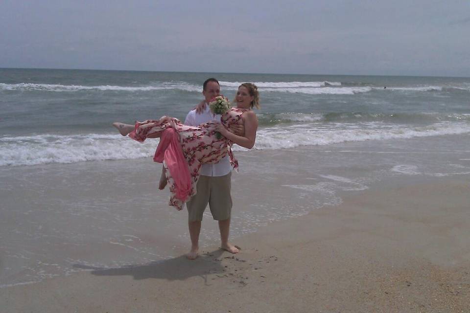 Groom carrying his bride