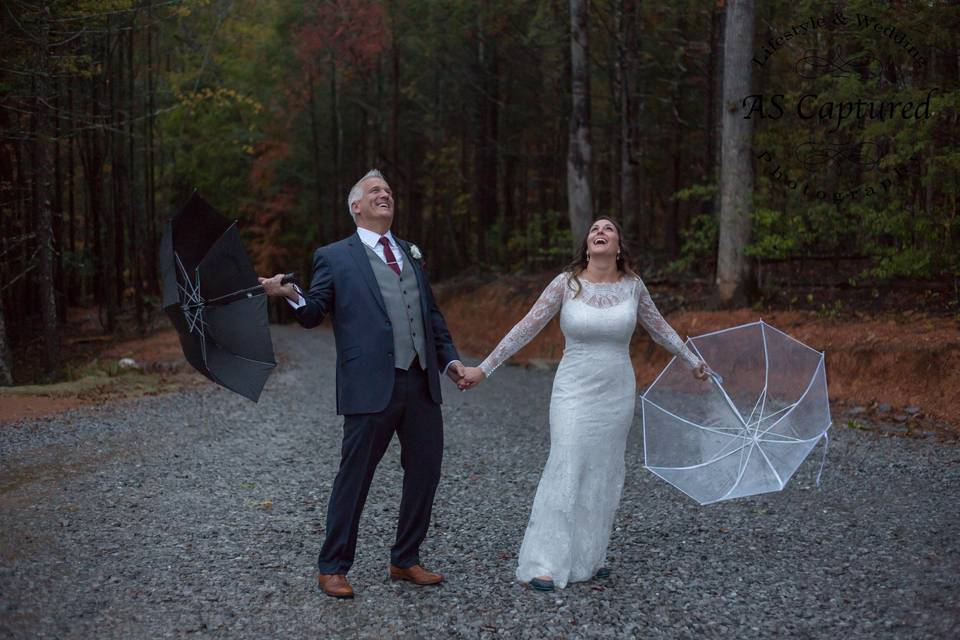 Bride & Groom Playing in Rain