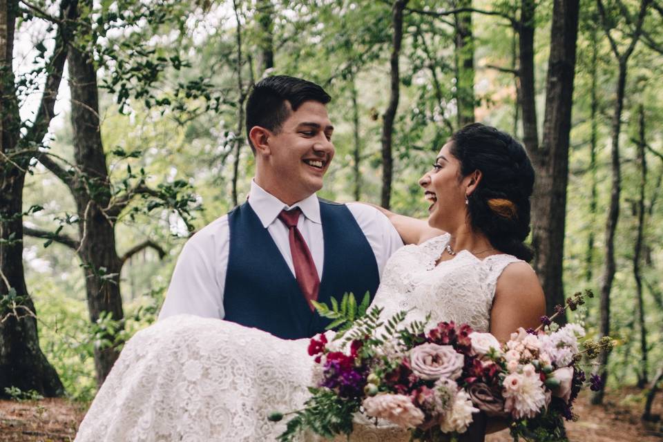 Groom carrying his bride