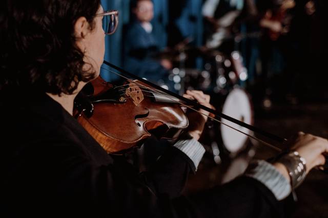 Violin with band on stage