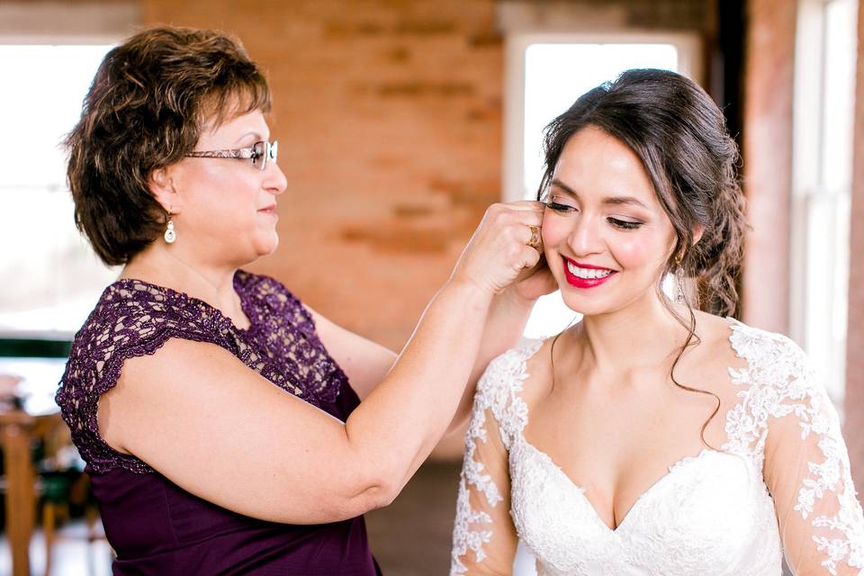 Helping the bride with her earrings