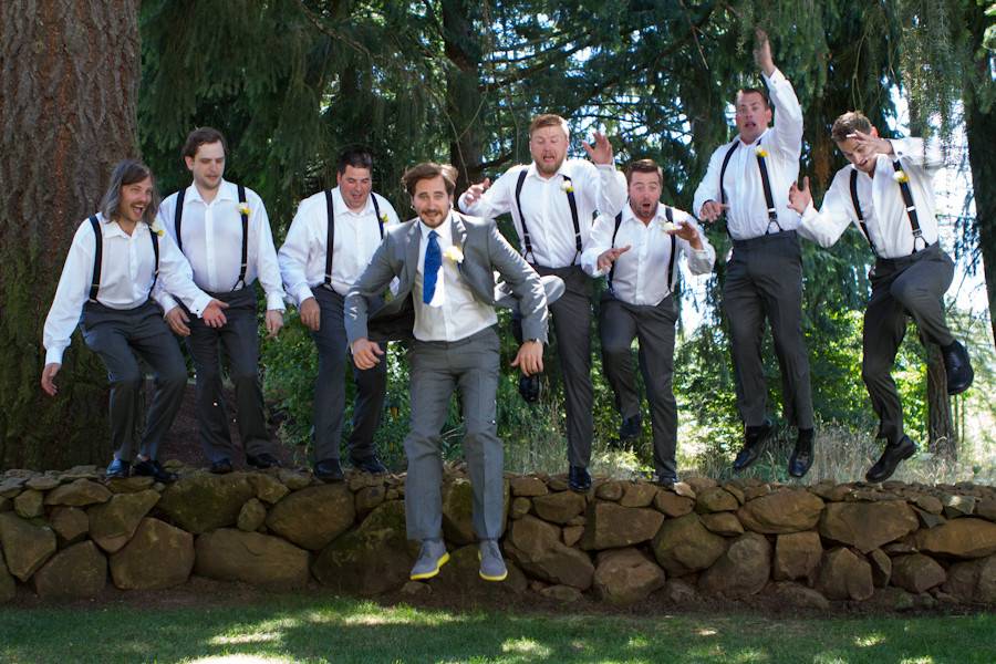 Groom and groomsmen jumping