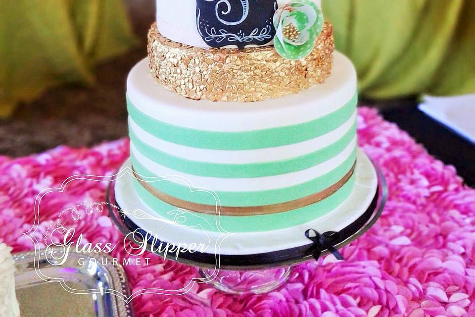 gold sequin, stripe and floral patterned cake with edible chalkboard monogram and wafer paper roses