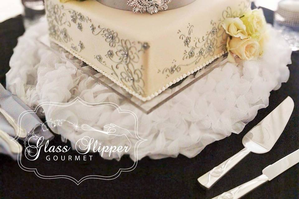 classic and elegant wedding cake in ivory, silver and black with bling and fresh flowers