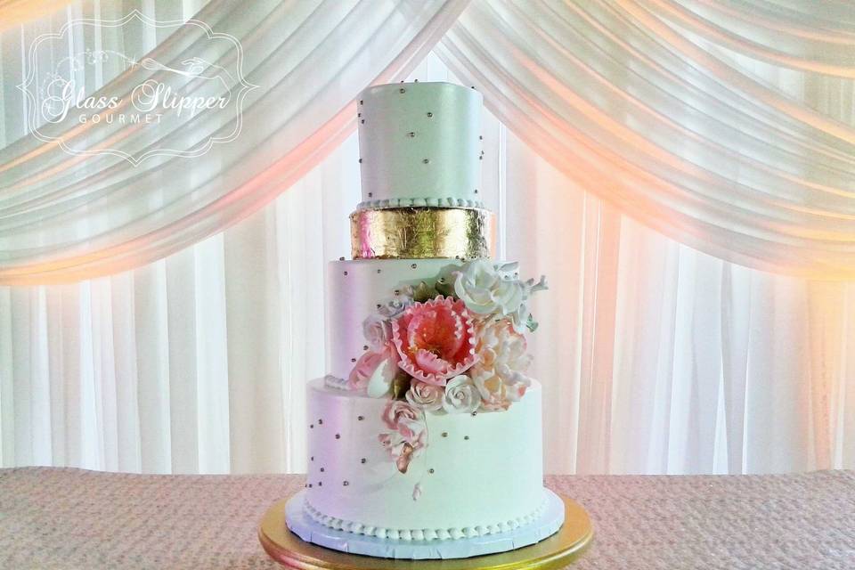 elegant white buttercream with edible gold accents and sugar flower bouquet