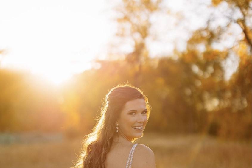 Bride standing in field