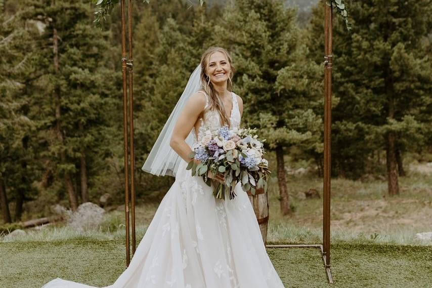 Bride standing infront of arch