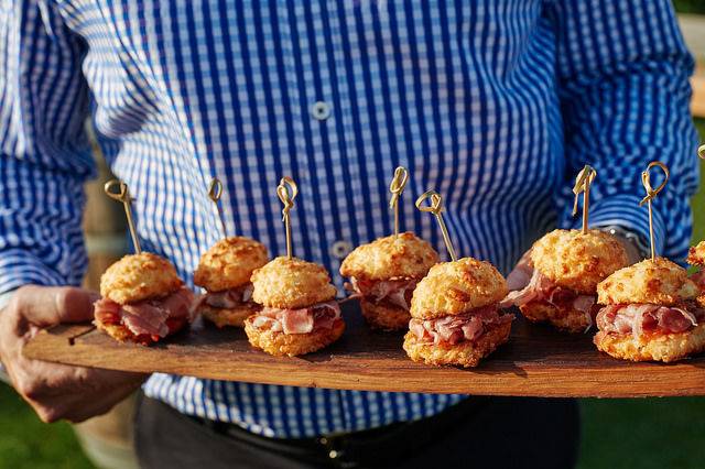Hand-passed mini ham sandwiches on cheddar biscuits