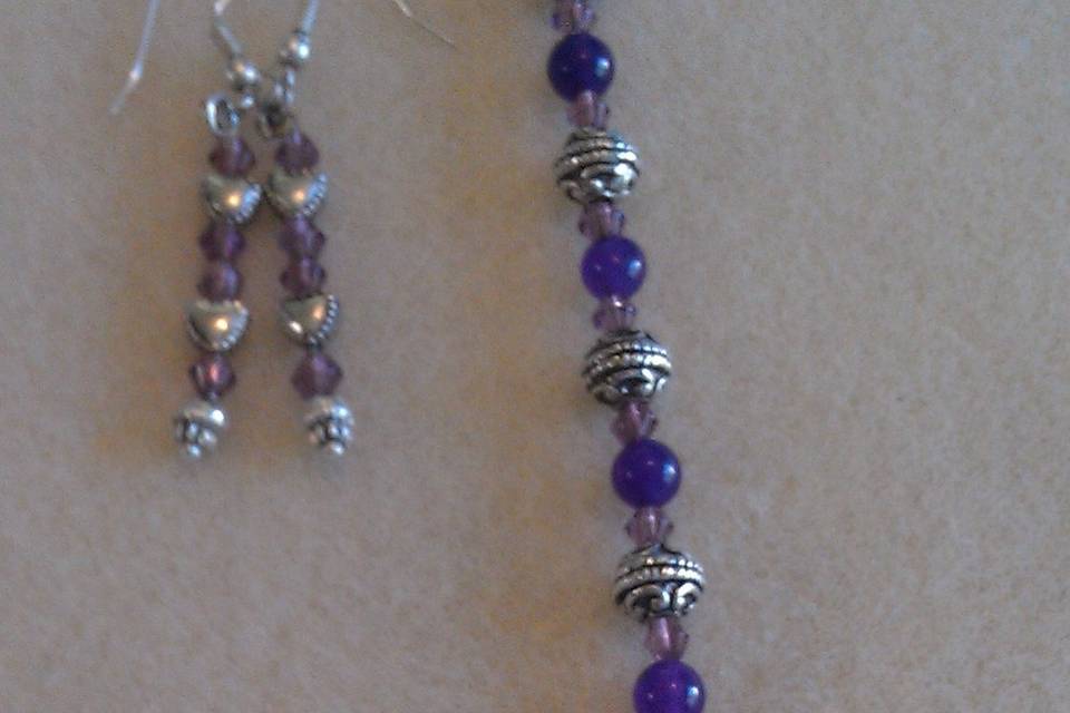The Bracelet is Purple Alexandrite (rare) and Beautiful Tibetan Silver Beads, the clasp is a Flower. This is a Gorgeous bracelet. This was a Bracelet and Earring set. The gowns were high cut. With short sleeves
Earrings are Purple Swarvoski Crystals with Tibetan Silver Heart Earrings it went with a set for a bridesmaids set
All Earring come with backings and the Tibetan Silver is Lead & Nickel Free.
This set went for $30 a set