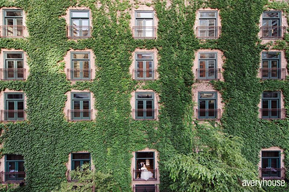 Bride & Groom standing in juliet balcony with ivy wallPhoto Credit: Avery Househttp://galleries.averyhouse.net