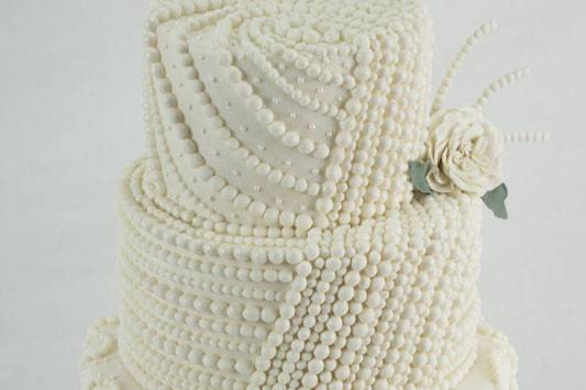 This wedding cake boasts incredible pearl detailing.