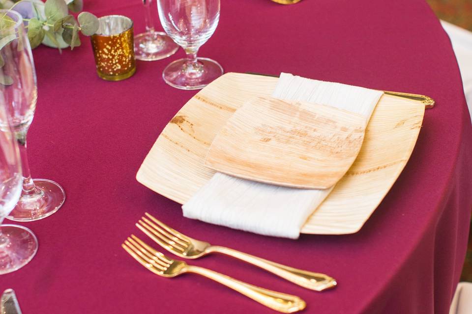 Gold cutlery and pink table cloth