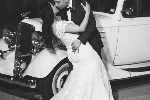 Couple kissing by car