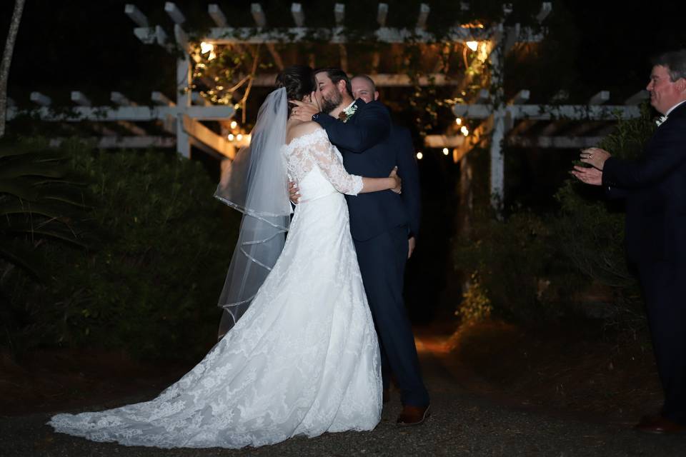 A couple kisses after their vows