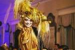 Stilt walker in gold