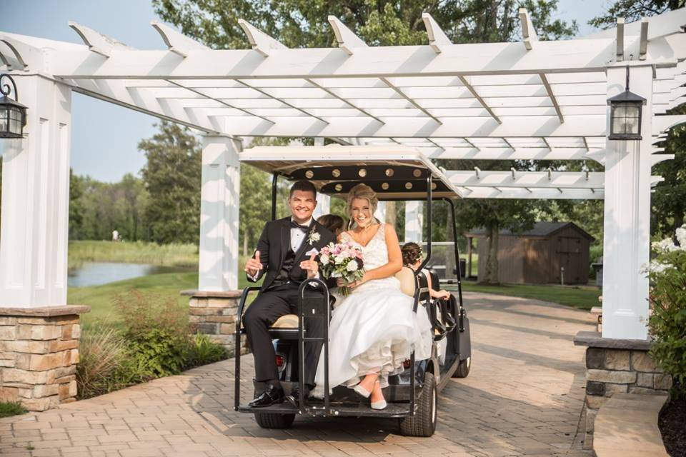 Couple riding a golf cart