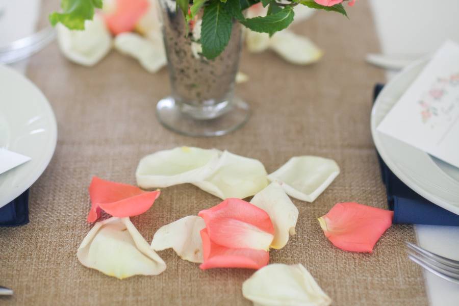 Table runner centerpieces with coral spray roses and fresh mint.Photo by Landino Photo