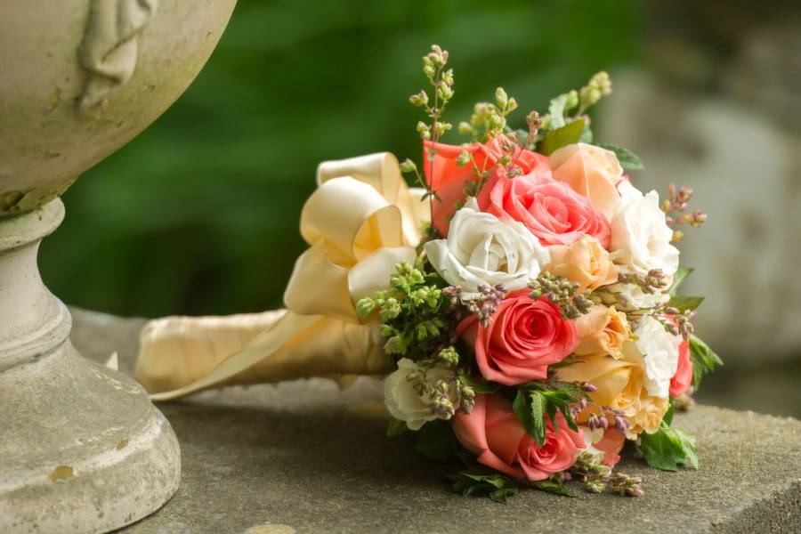 Coral and white rose bridesmaid bouquet with fragrant herbsPhoto by Landino Photo