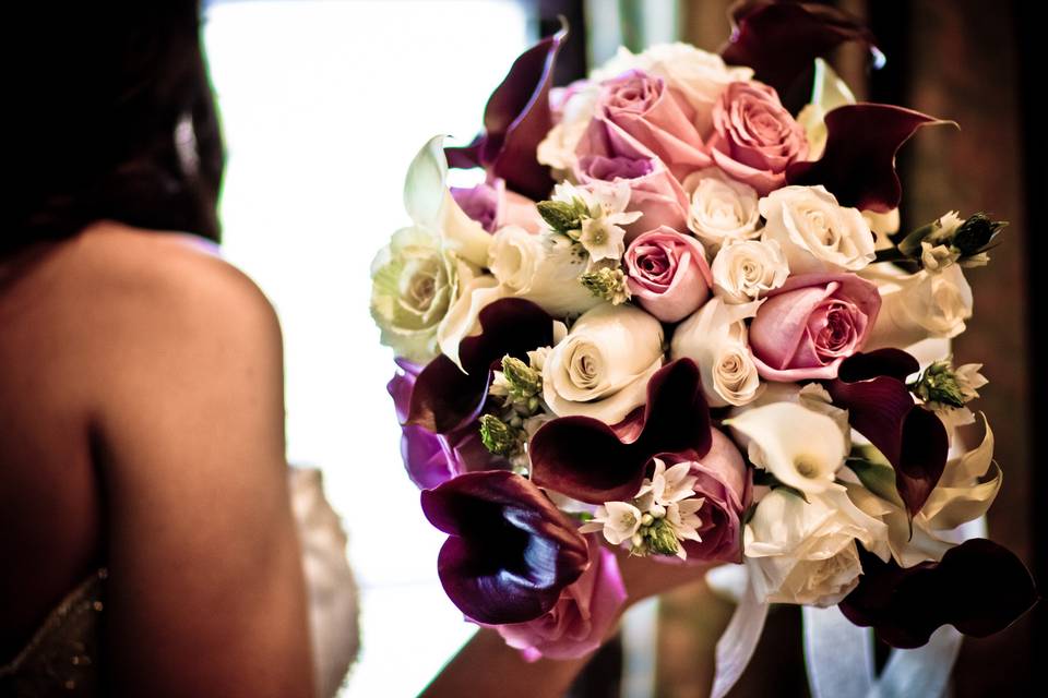 Romantic bridal bouquet with deep purple calla lilies