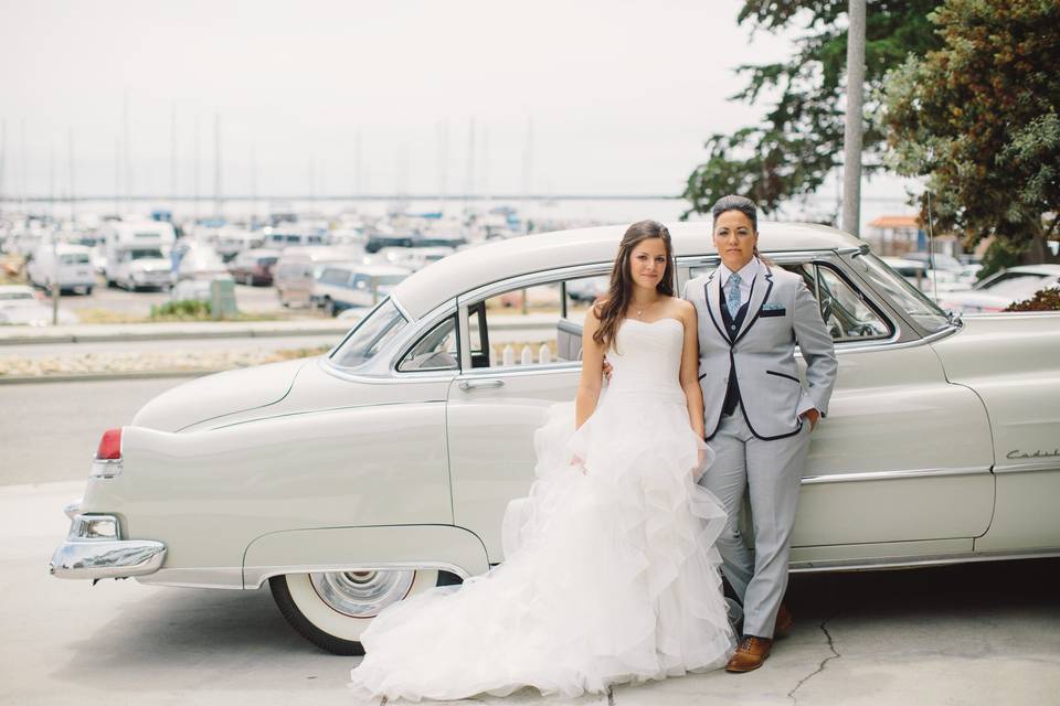 Newlyweds by the car