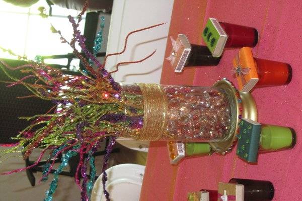 Great customized centerpieces bring together party colors, surrounded by handmade party favors.