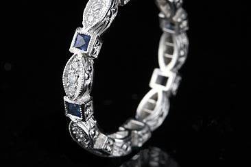 Vintage Platinum Diamond Sapphire Eternity Bandhttp://www.orospot.com/product/b72832mh/vintage-platinum-diamond-sapphire-eternity-band.aspxSKU: B72832MH$1,749.00Vintage Style Platinum Diamond (.15Cttw) and French Cut Sapphire (.40Cttw) Eternity Band This stackable, vintage style, platinum band is 2.7mm wide. Wedding ring contains seven French cut sapphire (approx. 40cttw) and eight pave set round diamonds (G-VS quality and .15cttw). Sides of this elegant band are engraved and top millegrainned. This band is available in most sizes. Please allow 2- 3 weeks to complete the order