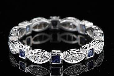 Vintage Platinum Diamond Sapphire Eternity Bandhttp://www.orospot.com/product/b72832mh/vintage-platinum-diamond-sapphire-eternity-band.aspxSKU: B72832MH$1,749.00Vintage Style Platinum Diamond (.15Cttw) and French Cut Sapphire (.40Cttw) Eternity Band This stackable, vintage style, platinum band is 2.7mm wide. Wedding ring contains seven French cut sapphire (approx. 40cttw) and eight pave set round diamonds (G-VS quality and .15cttw). Sides of this elegant band are engraved and top millegrainned. This band is available in most sizes. Please allow 2- 3 weeks to complete the order