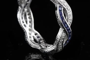 Infinity, eternity design band is made of 18K white gold and contains round cut diamonds (.40Cttw, G-VS quality) pave set and sapphire (.60Cttw) channel set. Wedding ring is engraved on the sides and top is millegrained. All finger sizes are available, please contact us for your size preference. Please allow 2- 3 weeks to complete this order.