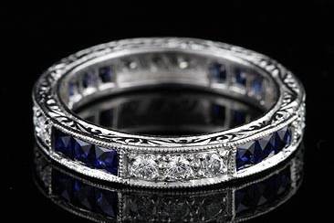 Art Deco Style Platinum Diamond Sapphire Wedding Eternity Band Ringhttp://www.orospot.com/product/b397155mh/art-deco-style-platinum-diamond-sapphire-wedding-eternity-band-ring.aspxSKU: B397155MH $2,499.00This gorgeous ,art deco design, platinum eternity band contains 12 French cut natural blue sapphires (Princess cut - approx. 1cttw) channel set and 12 round brilliant diamonds pave set (G-H color and VS clarity, approx. .35Cttw). This vintage inspired eternity ring is 3.6mm wide and approx 2mm tall. It is hand set, edges are milgrained and sides are engraved. Also available with rubies and diamonds (please contact us for more information). Please allow 2- 3 weeks to complete this order.
