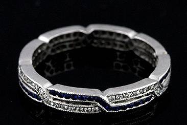 Art Deco Style 18K White Gold Diamond Sapphire Wedding Eternity Ringhttp://www.orospot.com/product/b54s01mh/art-deco-style-18k-white-gold-diamond-sapphire-wedding-eternity-ring.aspxSKU: B54S01MH $1,149.00This stylish ,art deco design, 18K white gold eternity band contains round diamonds (Brilliant cut Approx.23cttw, G-VS quality) channel set and round sapphires (Round cut Approx .23cttw). This Art Deco inspired eternity ring is 2.9mm wide and approx 1.65mm tall. It is hand set, edges are milgrained. Also available with rubies and diamonds (please contact us for more information). Band can be ordered in all sizes. Please allow 2- 3 weeks to complete this order.