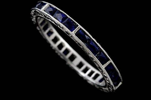 Platinum Art Deco Style French Cut Baguette Blue Sapphires Engraved Eternity Wedding Bandhttp://www.orospot.com/product/b50020mh/platinum-art-deco-style-french-cut-baguette-blue-sapphires-engraved-eternity-wedding-band.aspxSKU: B50020MH $1,719.00This vintage style engraved eternity blue sapphire wedding band is a 950 platinum piece. The height of this band is 2.3mm and the width is 2.35mm. This art deco style wedding band contains 1.44CT natural french cut baguette blue sapphires channel set all around the shank. The edges are milgrained and sides are beautifully engraved and high polished. Approximate Band Weight: 3.1 grams (ring size 6) This wedding band is available in all sizes, please contact us for your size preference. Please allow 2-3 weeks to complete the order.
