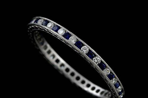 Platinum 950 Art Deco Style 0.35cttw Blue Sapphires and Diamonds Eternity Wedding Bandhttp://www.orospot.com/product/b5351023mh/platinum-950-art-deco-style-0-35cttw-blue-sapphires-and-diamonds-eternity-wedding-band.aspxSKU: B5351023MH$1,149.00This beautiful 950 platinum eternity wedding band contains high polish finish. The height of this band is 1.9mm and the width is 1.9mm. This vintage style wedding band contains 0.18CT round shape natural blue sapphires and 0.17CT round shape natural diamonds channel set around the shank. Also, this band is milgrained on the edges and it is beautifully engraved on both sides. Approximate Band Weight: 2.1 grams (ring size 6.25) This wedding band is available in all sizes, please contact us for your size preference. Please allow 2-3 weeks to complete the order.