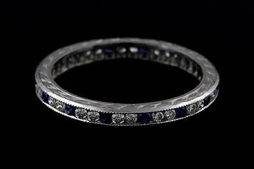 Diamond And Blue Sapphire Engraved Eternity Platinum Wedding Bandhttp://www.orospot.com/product/b5404110mh/diamond-and-blue-sapphire-engraved-eternity-platinum-wedding-band.aspxSKU: B5404110MH $1,259.00Eternity band contains full circle, channel set natural diamonds (G-VS quality) and blue sapphire (.40cttw). Vintage style reproduction platinum band is 2 mm wide and 1.6 mm tall. Sides are engraved and edges milgrained. Ring is available in all finger sizes, please allow 2-3 weeks to complete the order.