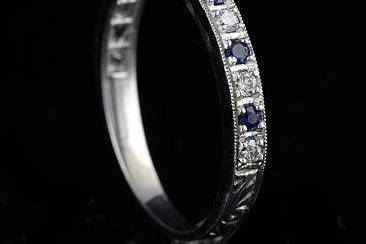 Vintage Style Diamond Sapphire Half Way Band 18KW Goldhttp://www.orospot.com/product/bppd12dsemh/vintage-style-diamond-sapphire-half-way-band-18kw-gold.aspxSKU: BPPD12DSEMH $599.00This vintage style reproduction wedding ring is made of 18k white gold. Band contains an alternating pattern of half way white, round diamonds (G-VS quality and approx. 15cttw) and blue round sapphires (approx. .15cttw). Band is beautifully engraved, edges are milgrained and top high polish. This 2.4mm wide ring is available in all finger sizes, please contact us for your size preference.
