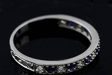 Vintage Style Diamond Sapphire Half Way Band 18KW Goldhttp://www.orospot.com/product/bppd12dsemh/vintage-style-diamond-sapphire-half-way-band-18kw-gold.aspxSKU: BPPD12DSEMH $599.00This vintage style reproduction wedding ring is made of 18k white gold. Band contains an alternating pattern of half way white, round diamonds (G-VS quality and approx. 15cttw) and blue round sapphires (approx. .15cttw). Band is beautifully engraved, edges are milgrained and top high polish. This 2.4mm wide ring is available in all finger sizes, please contact us for your size preference.