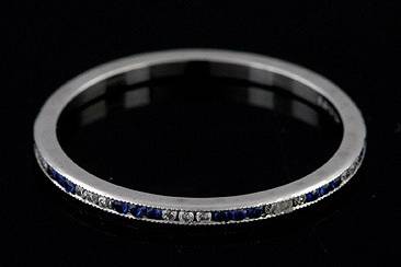 FINAL SALE 30% OFF Platinum Art Deco Style Diamond and Sapphire Stackable Eternity Band 1.4 Widehttp://www.orospot.com/product/b055993mhsale/final-sale-30-off-platinum-art-deco-style-diamond-and-sapphire-stackable-eternity-band-1-4-wide.aspxSKU: B055993MHSALE $769.00This delicate stackable mini platinum band is only 1.4 mm wide and 1.3 mm tall. Vintage style band contains .23cttw 3x3 channel set sapphires and diamonds. Sides are high polish and top milgrained. Ring is available in size 5.5