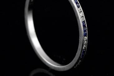 FINAL SALE 30% OFF Platinum Art Deco Style Diamond and Sapphire Stackable Eternity Band 1.4 Widehttp://www.orospot.com/product/b055993mhsale/final-sale-30-off-platinum-art-deco-style-diamond-and-sapphire-stackable-eternity-band-1-4-wide.aspxSKU: B055993MHSALE $769.00This delicate stackable mini platinum band is only 1.4 mm wide and 1.3 mm tall. Vintage style band contains .23cttw 3x3 channel set sapphires and diamonds. Sides are high polish and top milgrained. Ring is available in size 5.5
