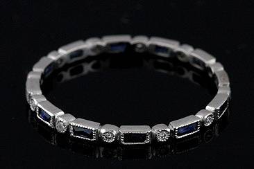 Final Sale 30% Off Platinum Art Deco Style Diamond and Blue Sapphire Stackable Eternity Ring Bandhttp://www.orospot.com/product/b780s117mhsale/final-sale-30-off-platinum-art-deco-style-diamond-and-blue-sapphire-stackable-eternity-ring-band.aspxSKU: B780S117MHSALE $909.00This beautiful stackable mini platinum band is only 1.7 mm wide and 1.5 mm tall. This Art Deco replica band contains 12 French cut blue sapphires baguettes (.30Cttw) set in channel and 12 tiny round bead set round brilliant diamonds (G-VS quality). Sides are high polish and top milgraied, band is available in size 7.75