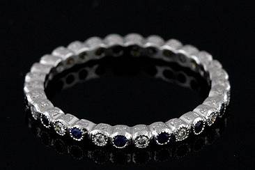 Platinum Stackable Diamond and Sapphire Engraved Eternity Band Ringhttp://www.orospot.com/product/b800171mh/platinum-stackable-diamond-and-sapphire-engraved-eternity-band-ring.aspxSKU: B800171MH$1,099.00Platinum Stackable Diamond and Sapphire Eternity Band Ring This stackable platinum wedding band is 1.9mm wide and 1.9mm tall. Vintage style platinum band contains an alternating pattern of white, brilliant cut, round diamonds (G-VS quality and approx. 15cttw) and blue round sapphires (approx. .18cttw). Sides of this elegant band are engraved and top is millegrainned. This ring is available in most sizes. Please allow 2- 3 weeks to complete the order