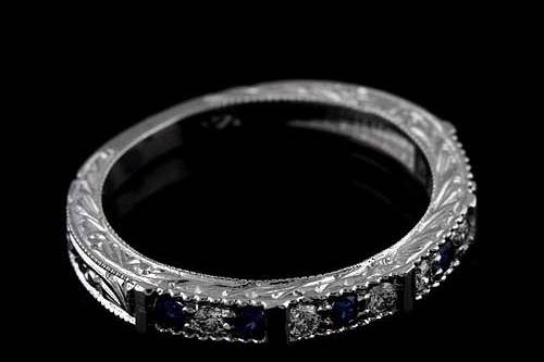 Prong Set Diamonds And Sapphire Engraved 14K White Gold Art Deco Reproduction Wedding Bandhttp://www.orospot.com/product/b2074wpp/prong-set-diamonds-and-sapphire-engraved-14k-white-gold-art-deco-reproduction-wedding-band.aspxSKU: B2074WPP$579.00Art Deco style inspired wedding band contains six prong set, natural, round diamonds .15cttw, G-SI1 quality and six round, blue sapphire approx .15cttw. Ring is 2.8 mm wide at the top of the shank and it is 2.2 wide at the bottom of the shank. The height at the top is 2.5 mm and the height at the bottom of the shank is 1.6 mm. Band is beautiful engraved 3/4 way and milgrained on the edges. Please allow 1-2 weeks to complete this order.