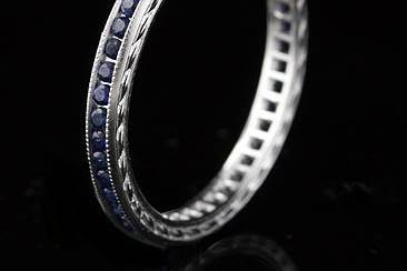 Vintage Style Engraved Platinum Sapphire Eternityhttp://www.orospot.com/product/b5402278mh/vintage-style-engraved-platinum-sapphire-eternity.aspxSKU: B5402278MH$1,249.00This stylish art deco inspired platinum wedding ring contains round cut blue sapphire (Approx. .40ct) channel set. This band is only 2.1 mm wide, has engraved sides and top edges milgrained. This band is available in all sizes, contact us for your size preference. Please allow 2- 3 weeks to complete the order